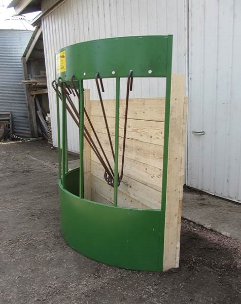 A Hay Manager feeder shown open to reveal the 18 adjustable cone rods and chain system that support the bale off the ground