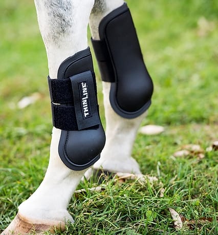 Black ThinLine horse boot fitted and conforming on a horse leg