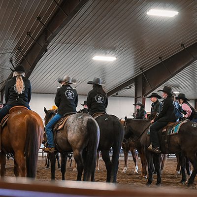 Montana Western natural horsemanship students mounted on horses in the Montana Center for Horsemanship indoor arena