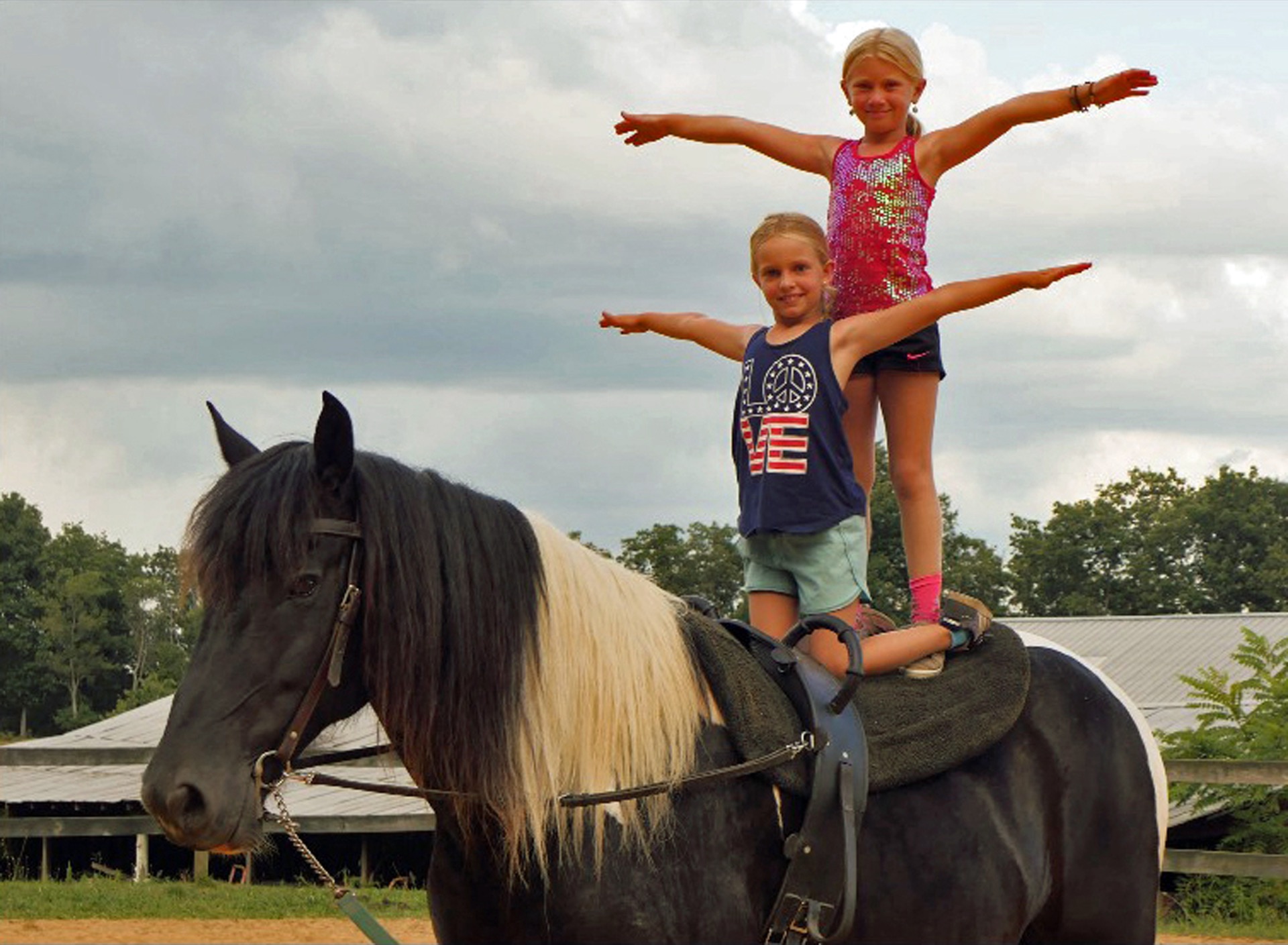 Valley View Vaulters performing gymnastic stunts standing on a vaulting horse