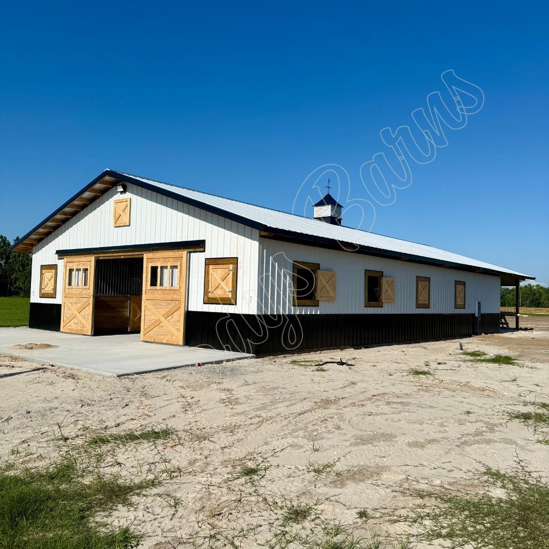 Woodys Barns custom center aisle horse barn with stalls built in Florida