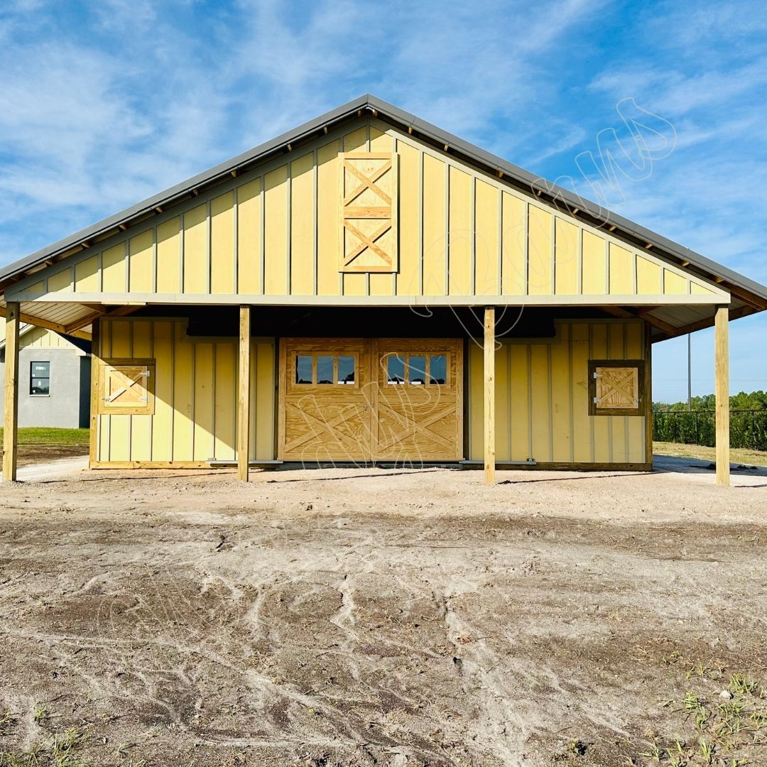Woodys Barns center aisle barn interior with custom horse stalls