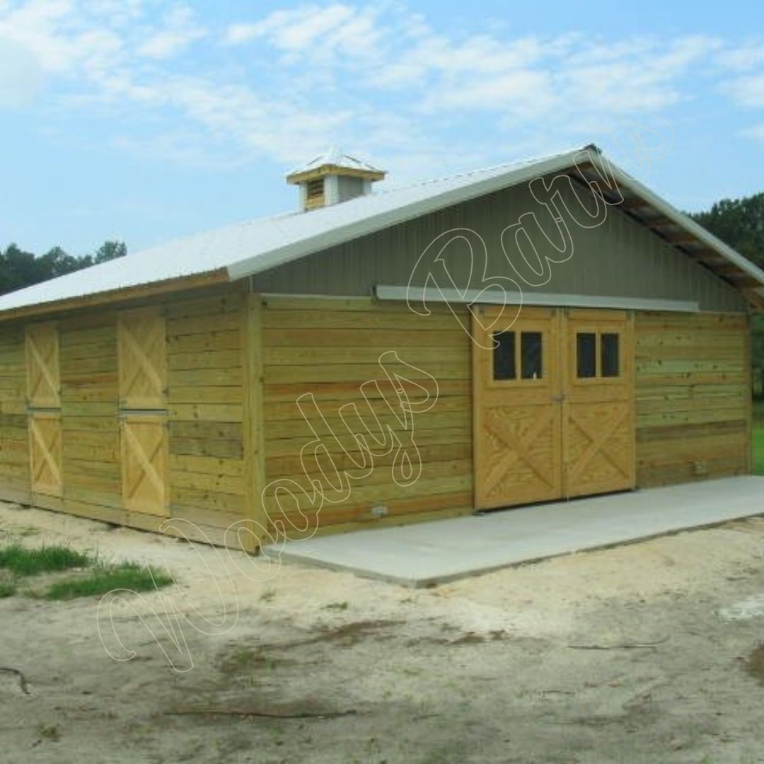 Woodys Barns custom built horse barn exterior with metal roof in Florida
