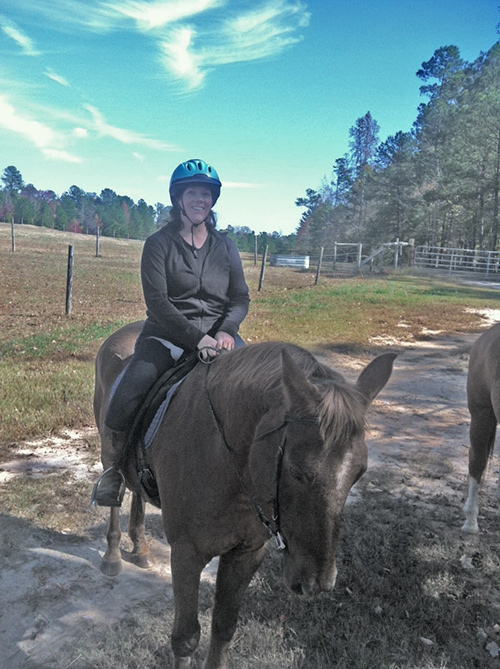 Adults safely riding horses.