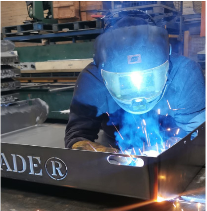 Man in steel workshop manufacturing Paddock Blade manure collection tray.